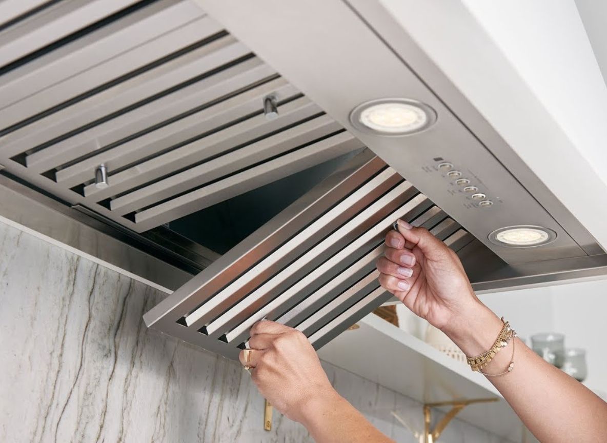 “Commercial kitchen hood filter removal for cleaning and maintenance in Dubai, UAE.”